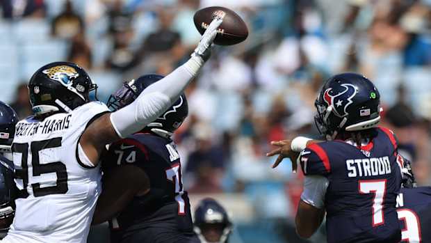 Texans' C.J. Stroud (7) is pressured by Jacksonville Jaguars defensive end Roy Robertson-Harris